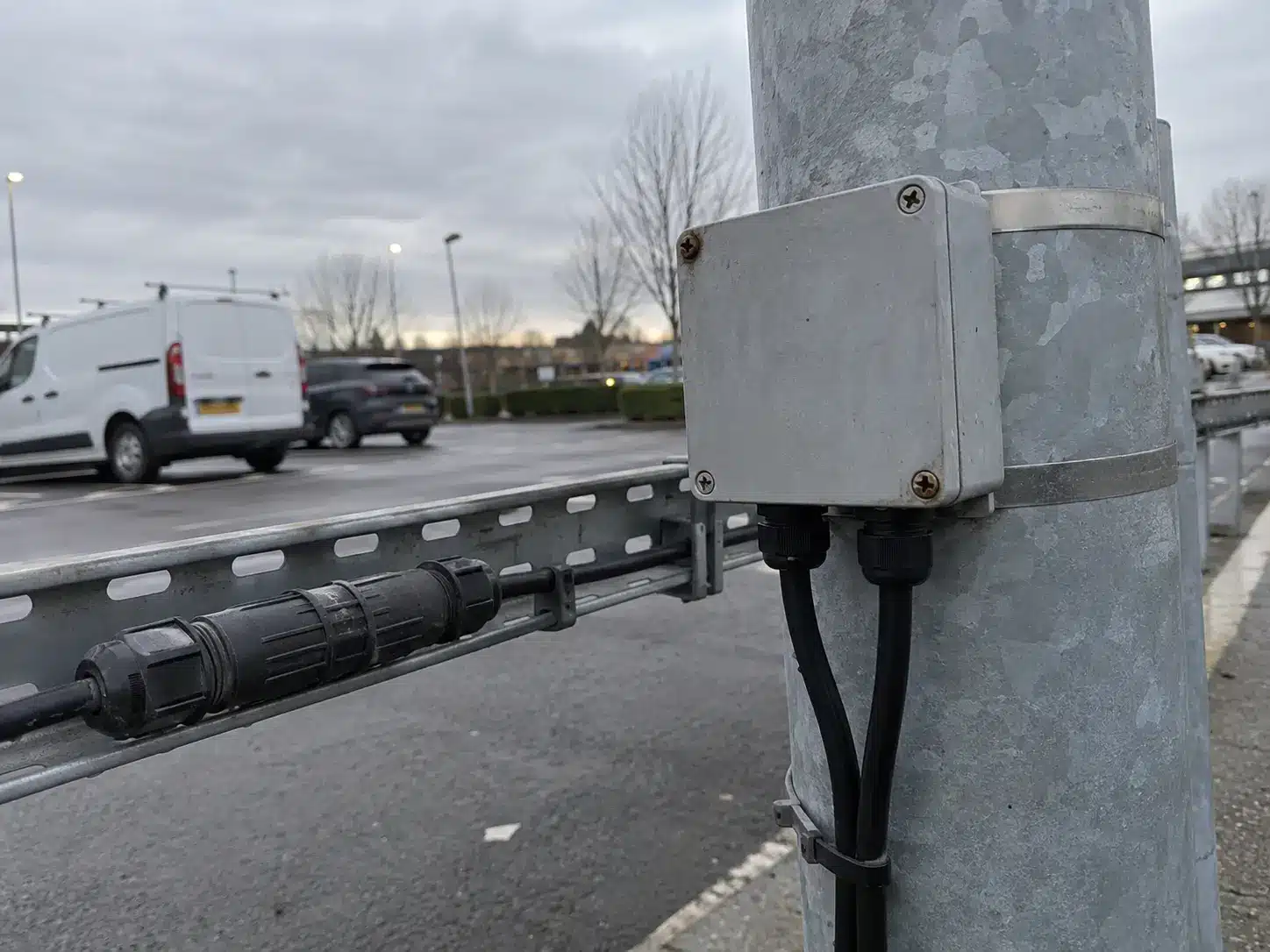 IP68 junction box fitted to a light pole next to a mated waterproof connector, showing two different ways to close an outdoor joint